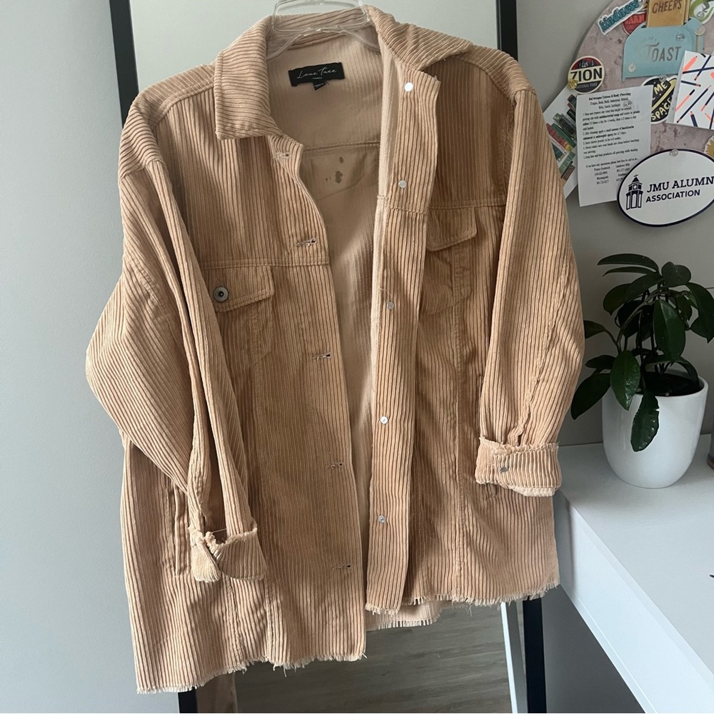tan corduroy shocker with front pockets and destroyed fringe hem
